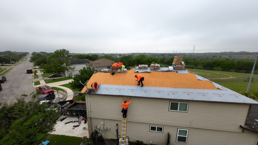 Roofers working on the roof of a house